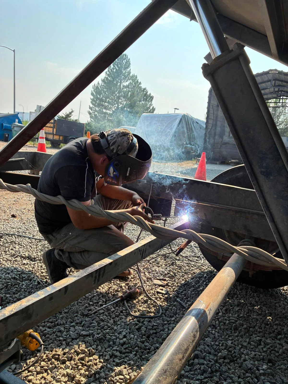 Mobile welder repairing a trailer axle on-site